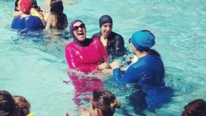 Muslim women fined €35 for defying burkinis ban at French pool.