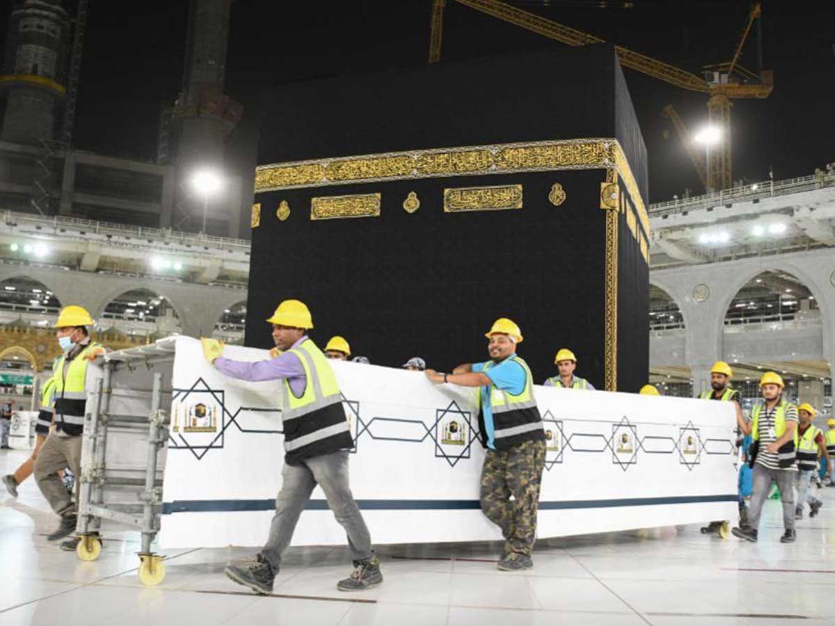 The Kaaba viewed from the courtyard of Masjid al-Haram with the Kiswa and golden door visible