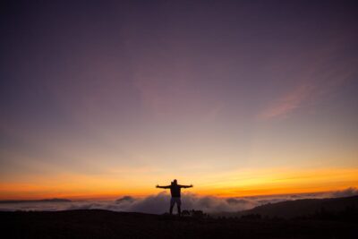 Silhouette of a person at sunrise expressing gratitude and saying alhamdulillah