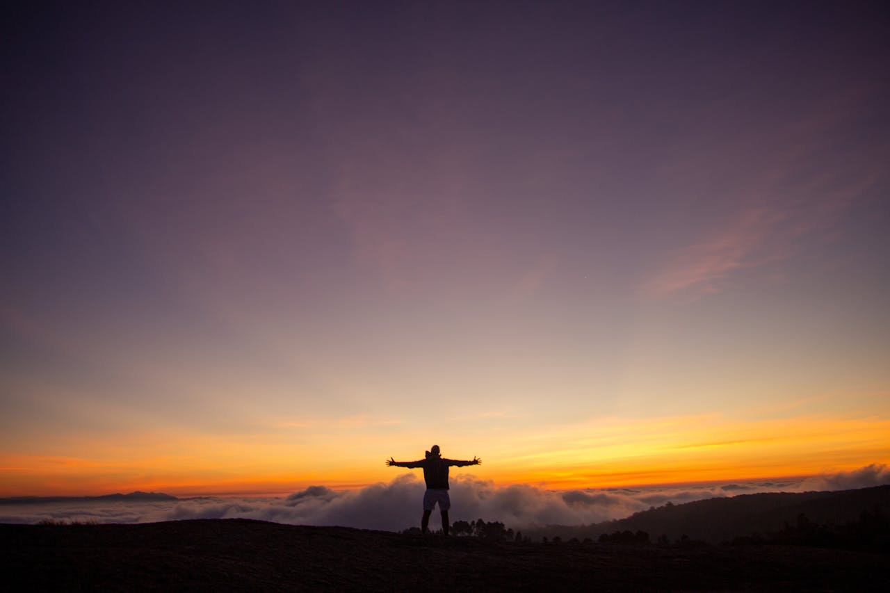 Silhouette of a person at sunrise expressing gratitude and saying alhamdulillah