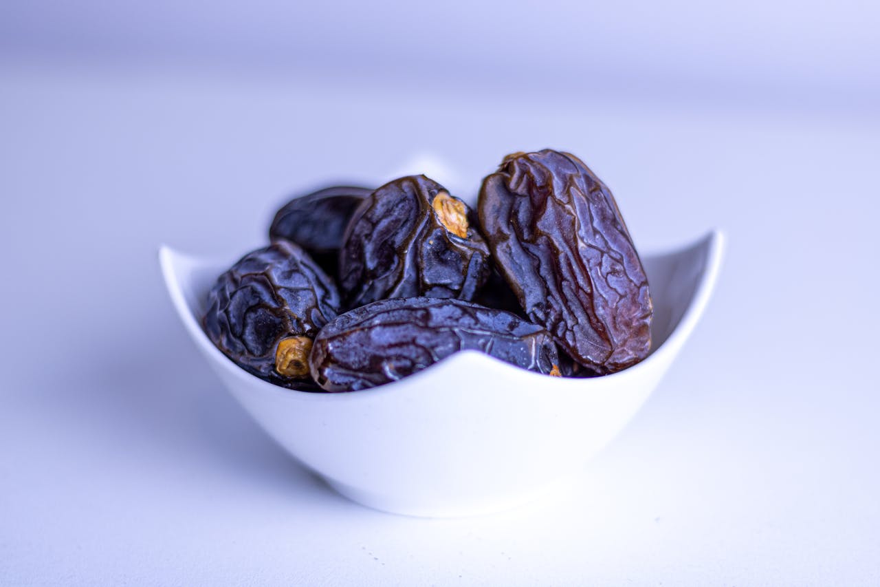 Fresh dates arranged in a decorative white bowl in Ramadan iftar setting